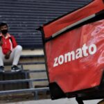A Zomato food delivery boy takes rest near a closed shop on the outskirts of New Delhi, India on 26 April 2020.