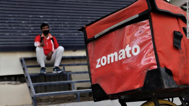 A Zomato food delivery boy takes rest near a closed shop on the outskirts of New Delhi, India on 26 April 2020.