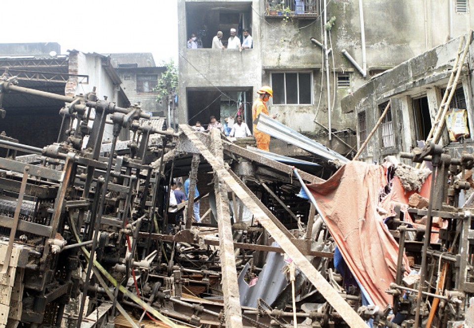 Indian National Disaster Response Force (NDRF) officials rescue people from the rubble of a three-storey Gilani building in Bhiwandi that collapsed on the outskirts of Mumbai, India, September, 21 2020.