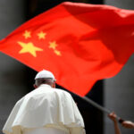 Worshipers wave the flag of China as Pope Francis leaves St. Peter's Square in the Vatican on June 12, 2019.