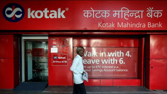 Kotak Mahindra Bank share price: A man walks past the Kotak Mahindra Bank branch in New Delhi, India.(