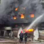 Black smoke and flames rise from a burning warehouse complex in Richland Compound, Bhiwandi, as firefighting teams battle the blaze.
